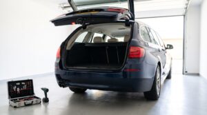 Kombi mit offener Heckklappe in der Garage, daneben Werkzeug zum Nachrüsten einer Rückfahrkamera